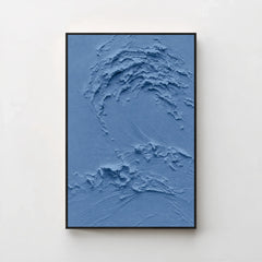 Creme No. 5 Blue — deep blue textured wave canvas print in a black gallery frame on a pale wall