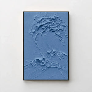 Creme No. 5 Blue — deep blue textured wave canvas print in a black gallery frame on a pale wall
