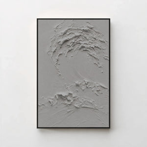 Creme No. 5 Graphite — grey textured wave canvas print in a black gallery frame on a pale wall