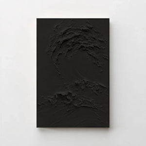 Creme No. 5 Noir — black textured wave canvas print in a black gallery frame on a pale wall