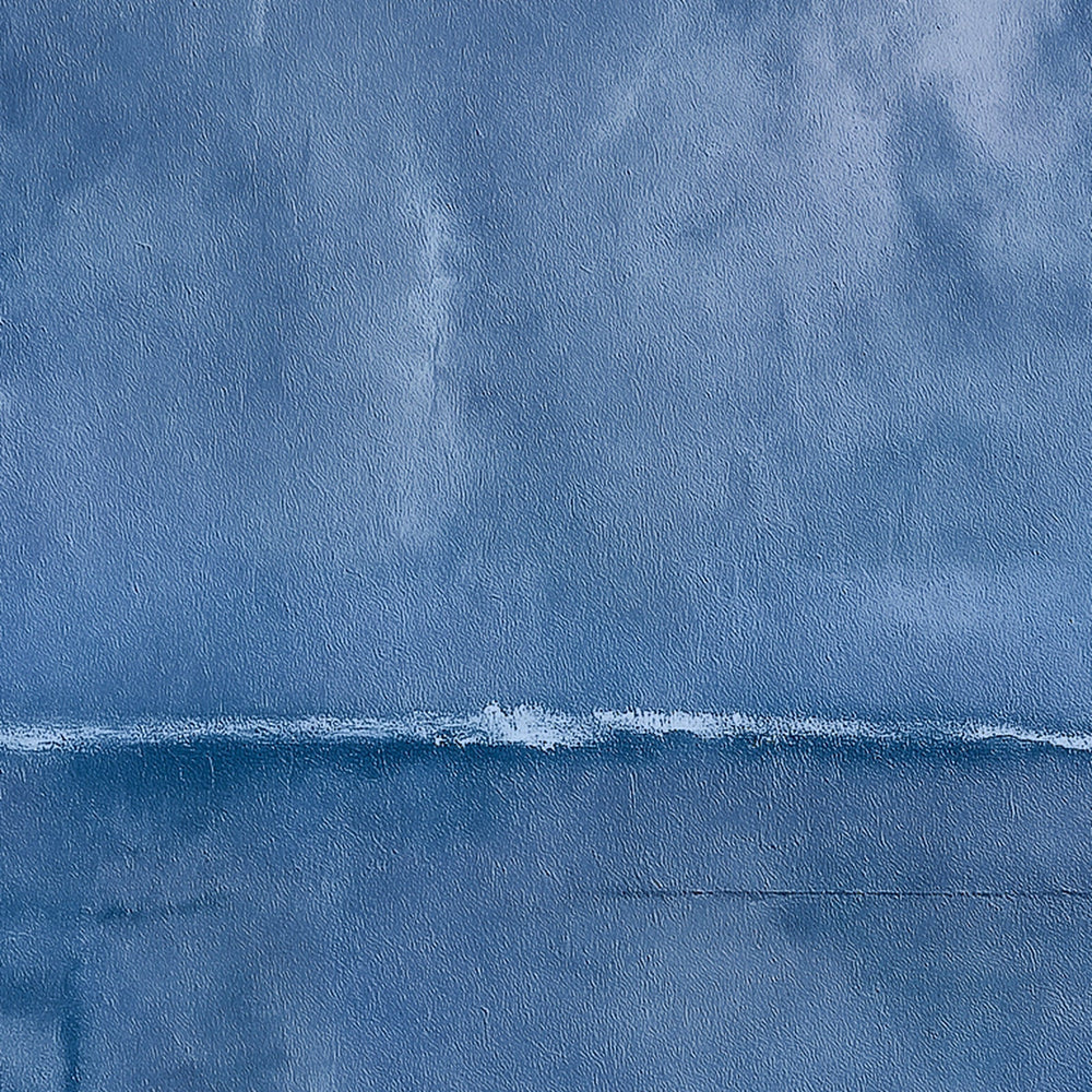 Harmonic Minimalism No. 27 Blue — deep blue seascape canvas print in a black gallery frame on a pale wall