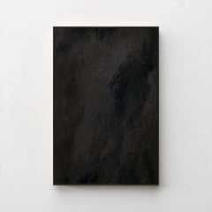 Harmonic Minimalism No. 1 Noir — dark charcoal gradient canvas print in a black gallery frame on a pale wall