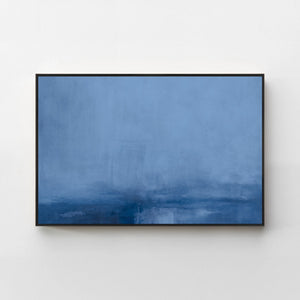 Harmonic Minimalism No. 31 Blue — deep blue horizontal landscape canvas print in a black gallery frame on a pale wall